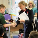 The Lord-Lieutenant presenting Junior Foresters' coins to Knutsford pupils